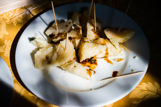 Balsamic vinegar drizzled over parmesan cheese